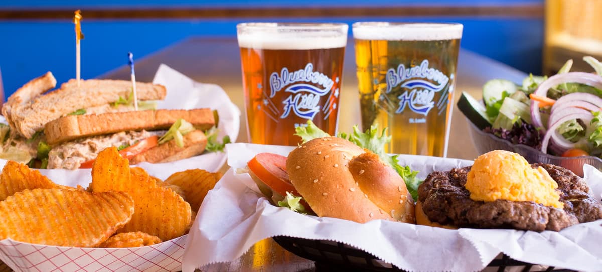 Sandwich, buffalo fries, burger with cheese, salad, two pints of beer